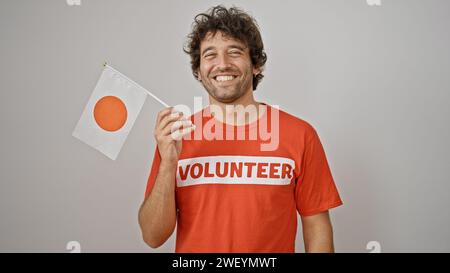 Young hispanic man activist holding japanese flag over isolated white background Stock Photo