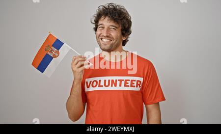 Young hispanic man activist holding serbia flag over isolated white background Stock Photo