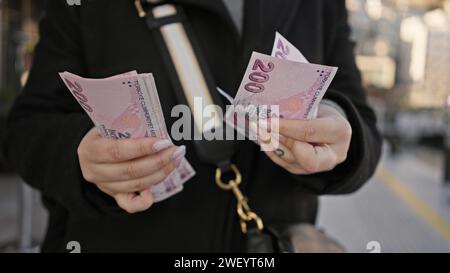 Close-up of woman counting turkish lira on istanbul street Stock Photo