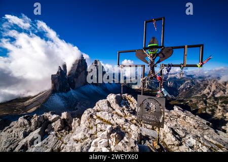 The north faces of the Tre Cime di Lavaredo rock formation in the Tre Cime National Park, surrounded by clouds, seen from Monte Paterno summit. Cortin Stock Photo