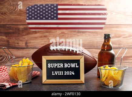 January 27, 2024: The 58th Super Bowl, football surrounded by snacks and beer and USA flag with a plaque reading Super Bowl LVIII 2024 PHOTO MONTAGE *** Der 58. Super Bowl, Football umgeben von Snacks und Bier und USA Flagge mit einer Tafel mit der Aufschrift Super Bowl LVIII 2024 FOTOMONTAGE Stock Photo