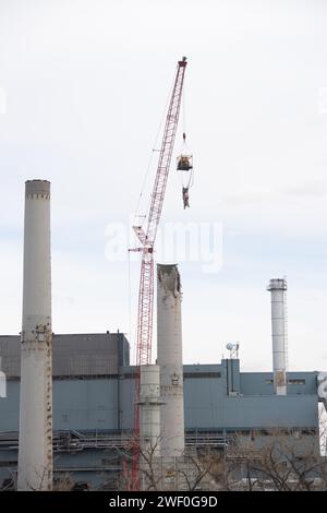 A crane takes down one of two smokestacks on the former coal burning power plant for Colorado Springs Utilities. Stock Photo