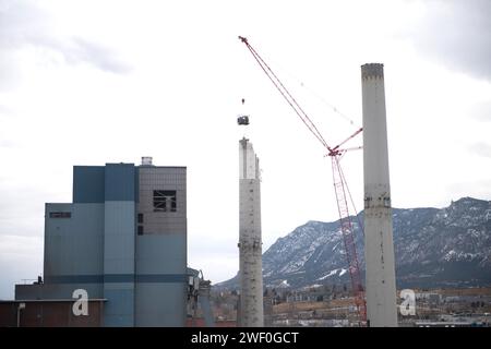 A crane takes down one of two smokestacks on the former coal burning power plant for Colorado Springs Utilities. Stock Photo