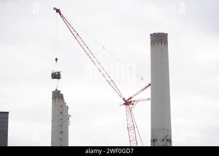 A crane takes down one of two smokestacks on the former coal burning power plant for Colorado Springs Utilities. Stock Photo