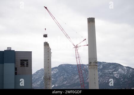 A crane takes down one of two smokestacks on the former coal burning power plant for Colorado Springs Utilities. Stock Photo