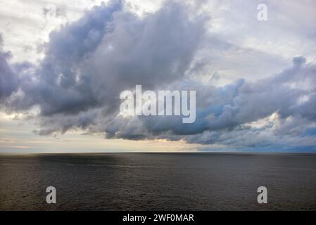 Cirrostratus and Stratocumulus clouds form over the Atlantic Ocean  to produce a dramatic sky. Stock Photo