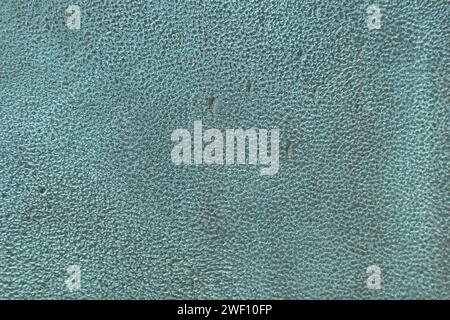 Detailed texture of copper oxide background. Background is a bronze plate covered with oxide green patina, the surface is rough with scratches and gouges. Rough Bronze Texture with Patina. Stock Photo