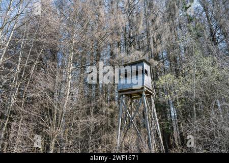 A hunters seat in the woods surrounded by trees in winter. Seen in a German forest. Stock Photo