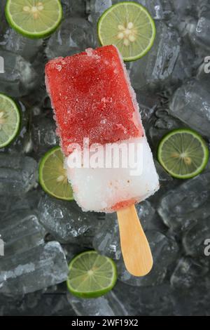Red and White Popsicle, Strawberry Lime Popsicles on Ice Stock Photo