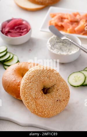 Bagels served with cream cheese, smoked salmon and fresh cucumber, sesame lox bagels Stock Photo