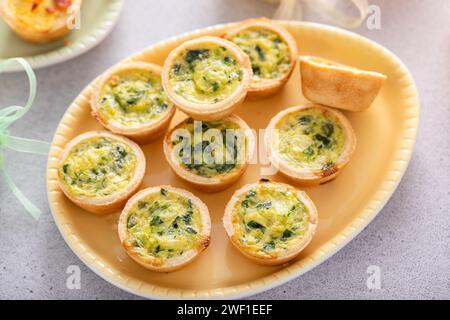 Mini quiches with spinach , ideas for Easter brunch or breakfast Stock Photo