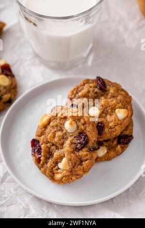 Cranberry and white chocolate cookies freshly baked served with milk Stock Photo
