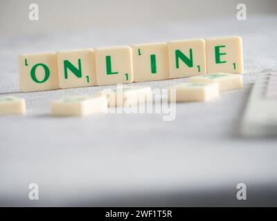 Scrabble letters spelling words Online. Online meaning are available on or performed using the internet or other computer network Stock Photo