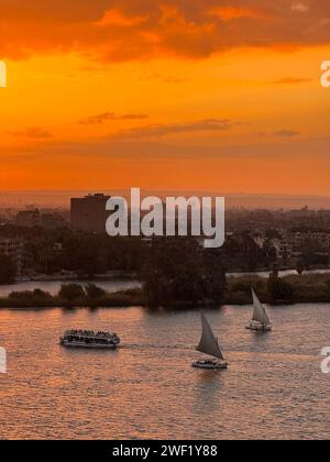 Cairo, Egypt. 27th Jan, 2024. Boats sail on the Nile River at sunset in Cairo, Egypt, on Jan. 27, 2024. Credit: Wang Dongzhen/Xinhua/Alamy Live News Stock Photo