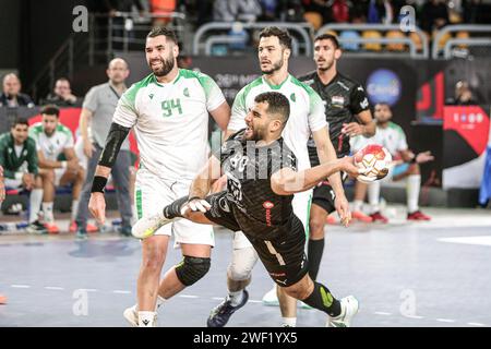 Cairo, Egypt. 27th Jan, 2024. Ahmed Abdel (front) of Egypt shoots during the final between Egypt and Algeria at the 2024 African Men's Handball Championship in Cairo, Egypt, Jan. 27, 2024. Credit: Ahmed Gomaa/Xinhua/Alamy Live News Stock Photo