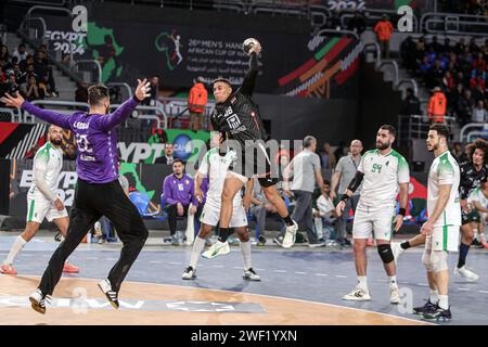 Cairo, Egypt. 27th Jan, 2024. Mohab Abdelhak (top) of Egypt shoots during the final between Egypt and Algeria at the 2024 African Men's Handball Championship in Cairo, Egypt, Jan. 27, 2024. Credit: Ahmed Gomaa/Xinhua/Alamy Live News Stock Photo