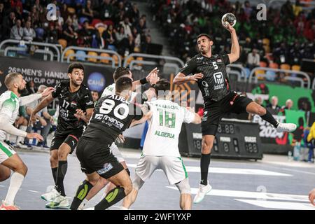 Cairo, Egypt. 27th Jan, 2024. Yahia Omar (top) of Egypt shoots during the final between Egypt and Algeria at the 2024 African Men's Handball Championship in Cairo, Egypt, Jan. 27, 2024. Credit: Ahmed Gomaa/Xinhua/Alamy Live News Stock Photo