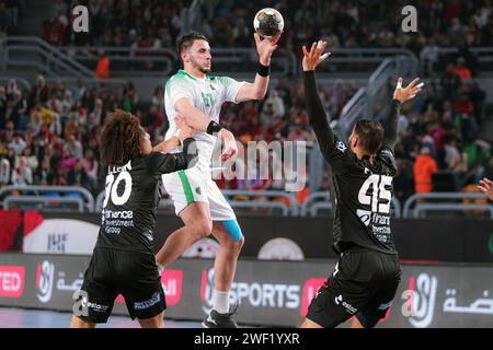 Cairo, Egypt. 27th Jan, 2024. Ayyoub Abdi (top) of Algeria shoots during the final between Egypt and Algeria at the 2024 African Men's Handball Championship in Cairo, Egypt, Jan. 27, 2024. Credit: Ahmed Gomaa/Xinhua/Alamy Live News Stock Photo