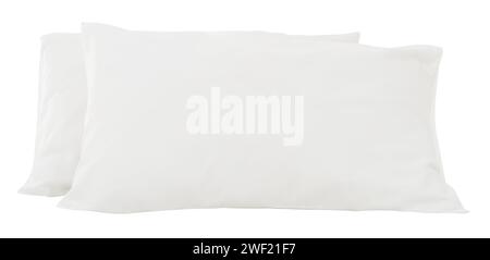 White pillows in stack after guest's use in hotel or resort room are isolated on white background with clipping path.  Concept of comfortable Stock Photo