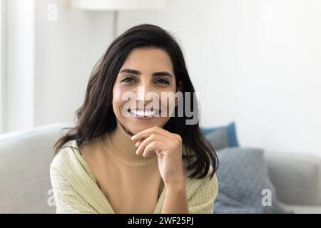 Cheerful beautiful Latin woman looking at camera with toothy smile Stock Photo