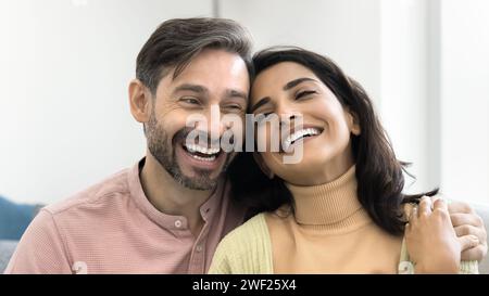 Positive cheerful middle aged family couple hugging at camera Stock Photo