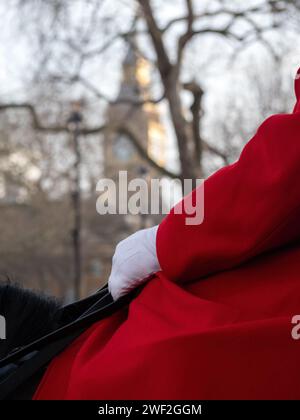 LONDON, UK - JANUARY 27, 2024:  Partial view of a Life Guard of the Household Cavalry on Guard at Horse Guards in Westminster with  Big Ben in the bac Stock Photo