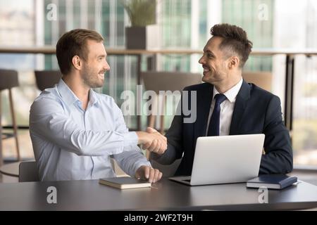 Happy successful business partners men shaking hands Stock Photo