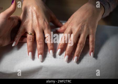 Close up of Senior client getting nails done at home Stock Photo