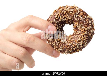 Human hand holding chocolate and crushed nuts donut, front view, isolated on white background Stock Photo