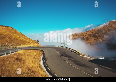 Alpine winding highway above the clouds. Pyrenees, Andorra, Europe Stock Photo
