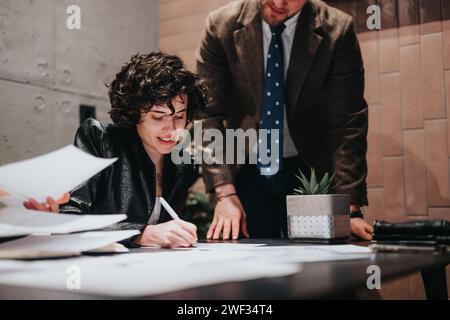 Business teammates collaboration in office setting with project plans. Stock Photo