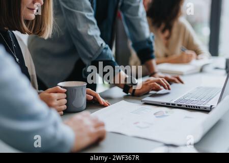 Business coworkers discussing reports and analyzing statistics in a creative office. Close up shot. Stock Photo
