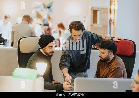 A collaborative workplace atmosphere between multiracial people is highlighted by teamwork and cooperation. Stock Photo