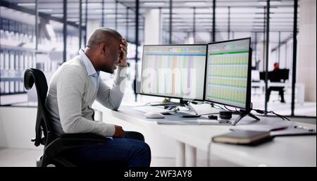 Data Analyst African Man Using Spreadsheet On Computer Stock Photo