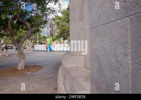 Tourists and visitors at the Santa Elena park in the centre of the Tenerife city of Santa Cruz having their photo in front of the Santa Cruz sculpture. Stock Photo