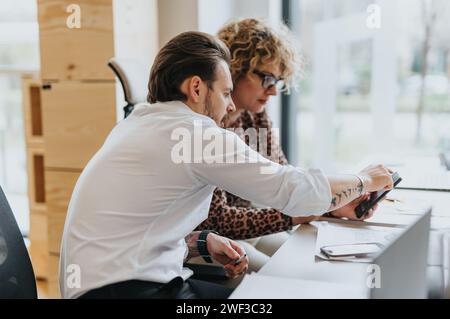 Multi generational group of businesspeople discussing ideas and collaborating on a project in a corporate office. Stock Photo