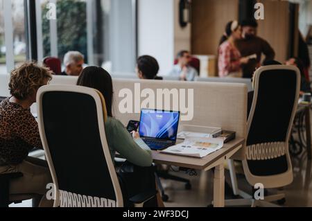 Diverse team of professionals working in a busy office environment Stock Photo