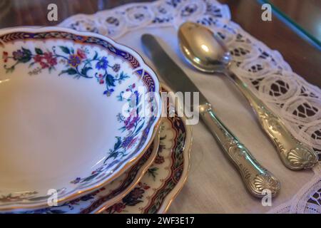 Old fashioned stylish dinner table in rustic atmosphere in old house Stock Photo