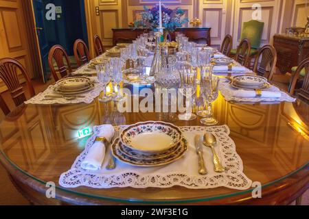 Old fashioned stylish dinner table in rustic atmosphere in old house Stock Photo