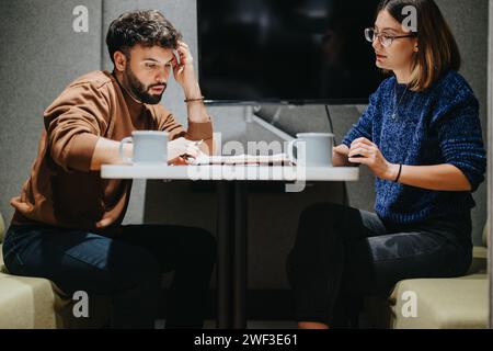 Two colleagues in serious business discussion at a modern office. Stock Photo