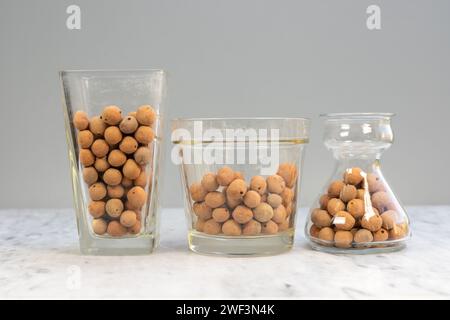 Light weight expanded aggregate balls in glass transparent vase and pots Stock Photo