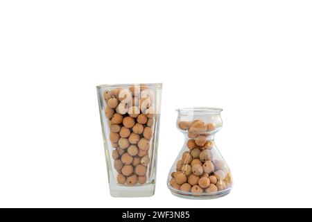 Baked clay balls for indoor plants in glass vases on white isolated background Stock Photo