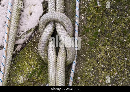 The Reef Knot or Square Knot. Rope knot of a large fishing vessel in the port of Grado. Equipment for the fishing industry. Used by sailors. Stock Photo