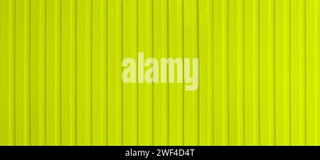 Wide surface of the yellow aluminum wall for background design. Stock Photo