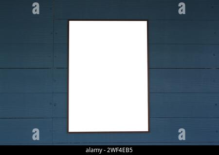 Empty picture frames on a dark wooden blue wall for design and ideas in your work. Stock Photo