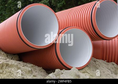 large plastic corrugated pipes on the road Stock Photo