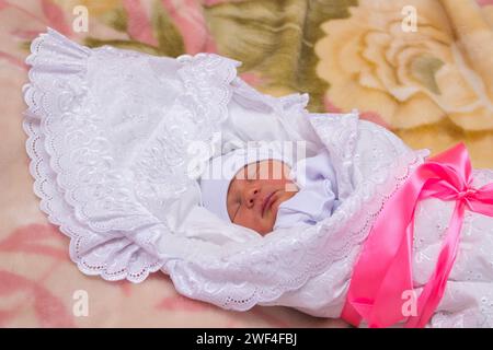 sleeping newborn baby in envelope for discharge from the hospital Stock Photo