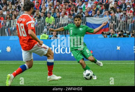 Moscow, Russia – June 14, 2018. Saudi Arabia national football team left winger Yahia Alshehri against Russia player Yuri Zhirkov during opening match Stock Photo
