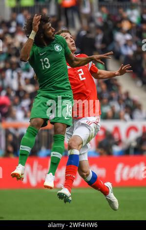 Moscow, Russia – June 14, 2018. Saudi Arabia national football team right-back Yasser Alshahrarani against Russia player Mario Fernandes during openin Stock Photo