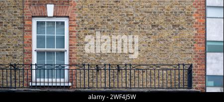 classic white windows of typical London architecture with red brick wall, panorama banner Stock Photo